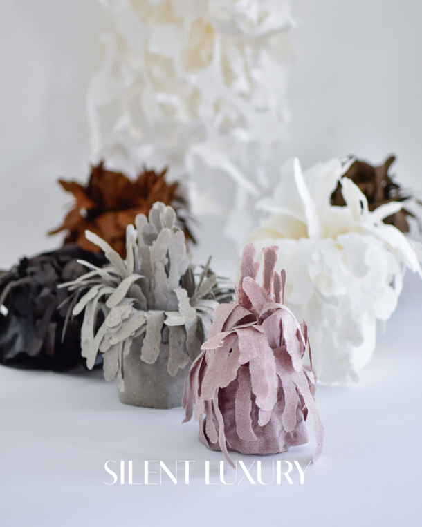 Sculptural mycelium paper objects by Tanja Major in white, grey, blush and deep natural tones, showing layered organic forms developed from fungi as a compostable material between textile art, paper making and material innovation.