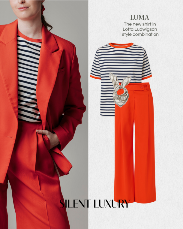 Lotta Ludwigson LUMA Bio-Circular T-Shirt in navy-white stripes with orange contrast collar, styled with the ALVA wide-leg trousers and blazer in tangerine red and the SILKY BEIGE silk foulard — a complete Lotta Ludwigson look combining the new LUMA Essential with the bio-circular ALVA suit collection.