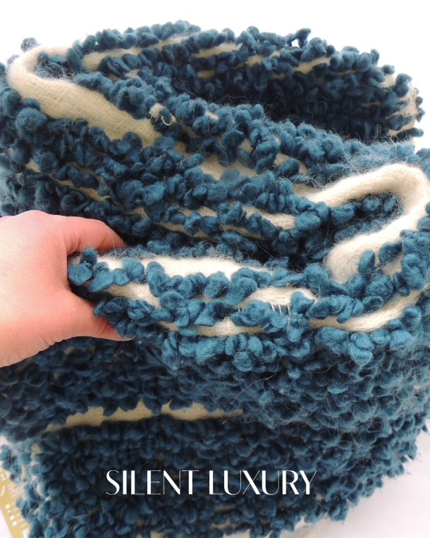 Textured surface of D-Leite by Inés Rodríguez with casein fibre, Merino wool and structural insertions