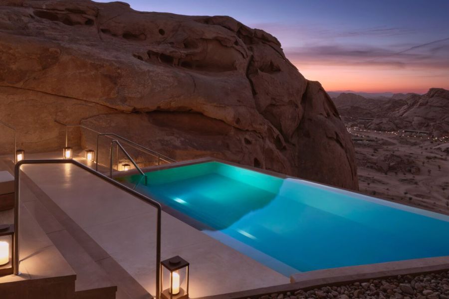 Infinity pool at Desert Rock Resort, integrated into the rocky Hejaz Mountains landscape at sunset, symbolizing luxury, slow hospitality and architectural harmony with nature.