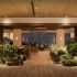The garden lounge at 1 Hotel Tokyo, 38th floor of the Akasaka Trust Tower — mossed boulders, botanical installations and a reclaimed timber ceiling opening onto the Tokyo skyline at dusk. | Photo: 1 Hotel Tokyo