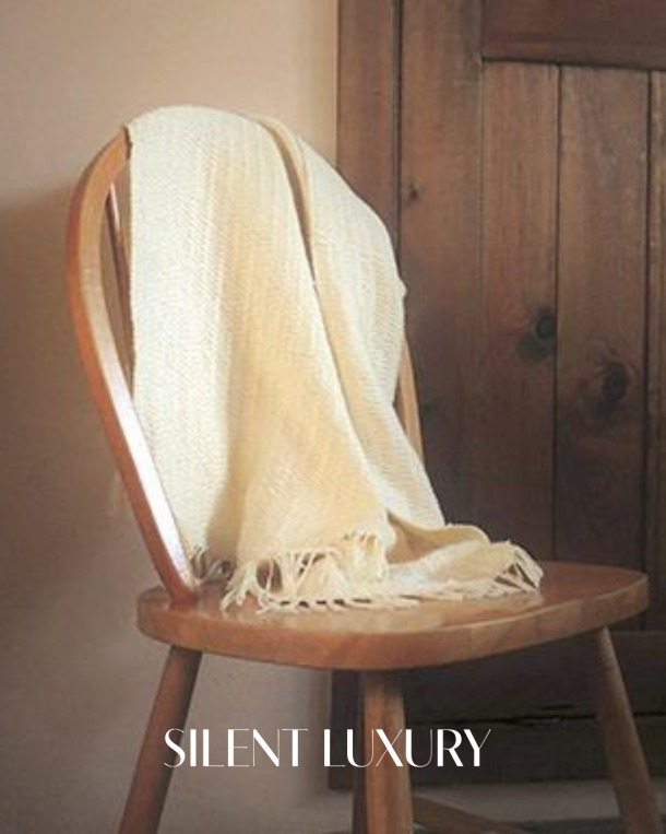 D-Leite by Ines draped over a wooden chair