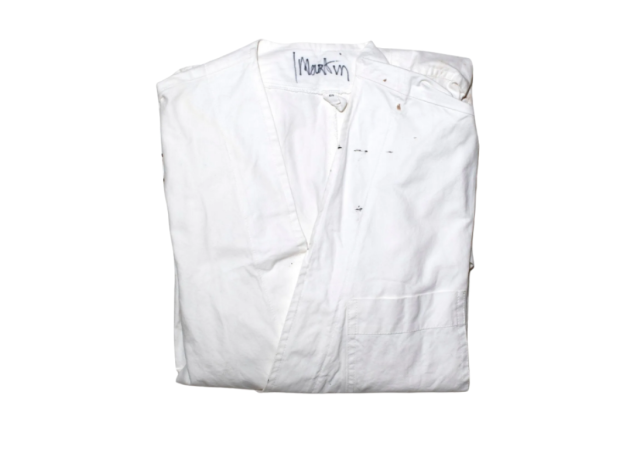 Lot 16, the white studio coat Martin Margiela wore in his atelier, signed "Martin" at the collar. Est. €6,000–10,000. Courtesy of Maurice Auction & Kerry Taylor Auctions
