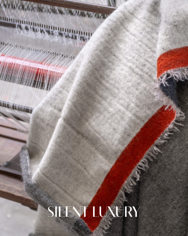 Coastland woven blanket draped over a loom in the workshop