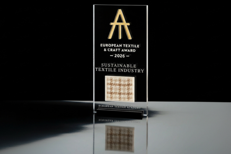 The European Textile & Craft Award 2026 trophy features a Lanificio Bottoli fabric sample dyed with coffee grounds, marking the material focus of this year’s Sustainable Textile Industry award.