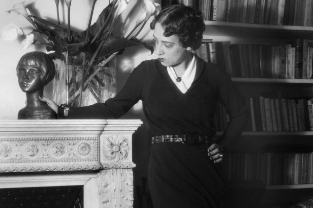 Elsa Schiaparelli at home, among books and arum lilies, 1936. Photograph by Boris Lipnitzki. Credit: APA-Images / Roger Viollet / Boris Lipnitzki.