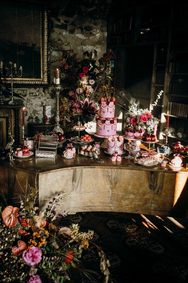 A dramatic wide shot of the Dulcesserie "Extra Ordinary" dessert display on a black grand piano, showcasing the architectural precision of the tiered cakes.