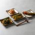 The everyday architecture of a Korean table: four kinds of kimchi, four handmade plates, one pair of chopsticks. In Busan, this is where the city begins. The Silent Luxury, June 2026. | Photo: magnific.com