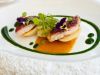 Dish by Chef Mario Stellato at Ristorante Pietre, Borgo La Pietraia — pan-seared fish with herb sauce, edible flowers and seasonal Cilento produce