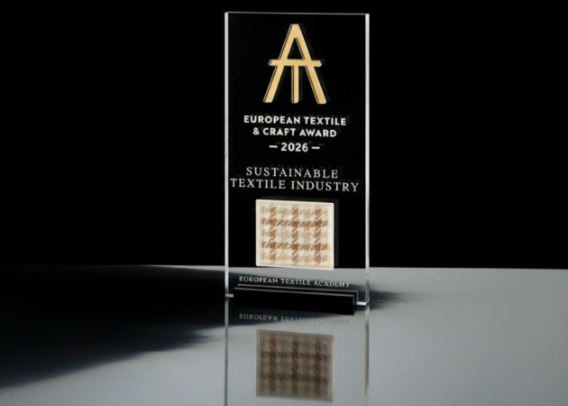 The European Textile & Craft Award 2026 trophy features a Lanificio Bottoli fabric sample dyed with coffee grounds, marking the material focus of this year’s Sustainable Textile Industry award.