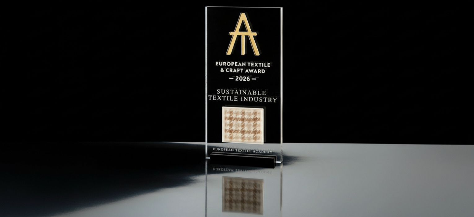 The European Textile & Craft Award 2026 trophy features a Lanificio Bottoli fabric sample dyed with coffee grounds, marking the material focus of this year’s Sustainable Textile Industry award.