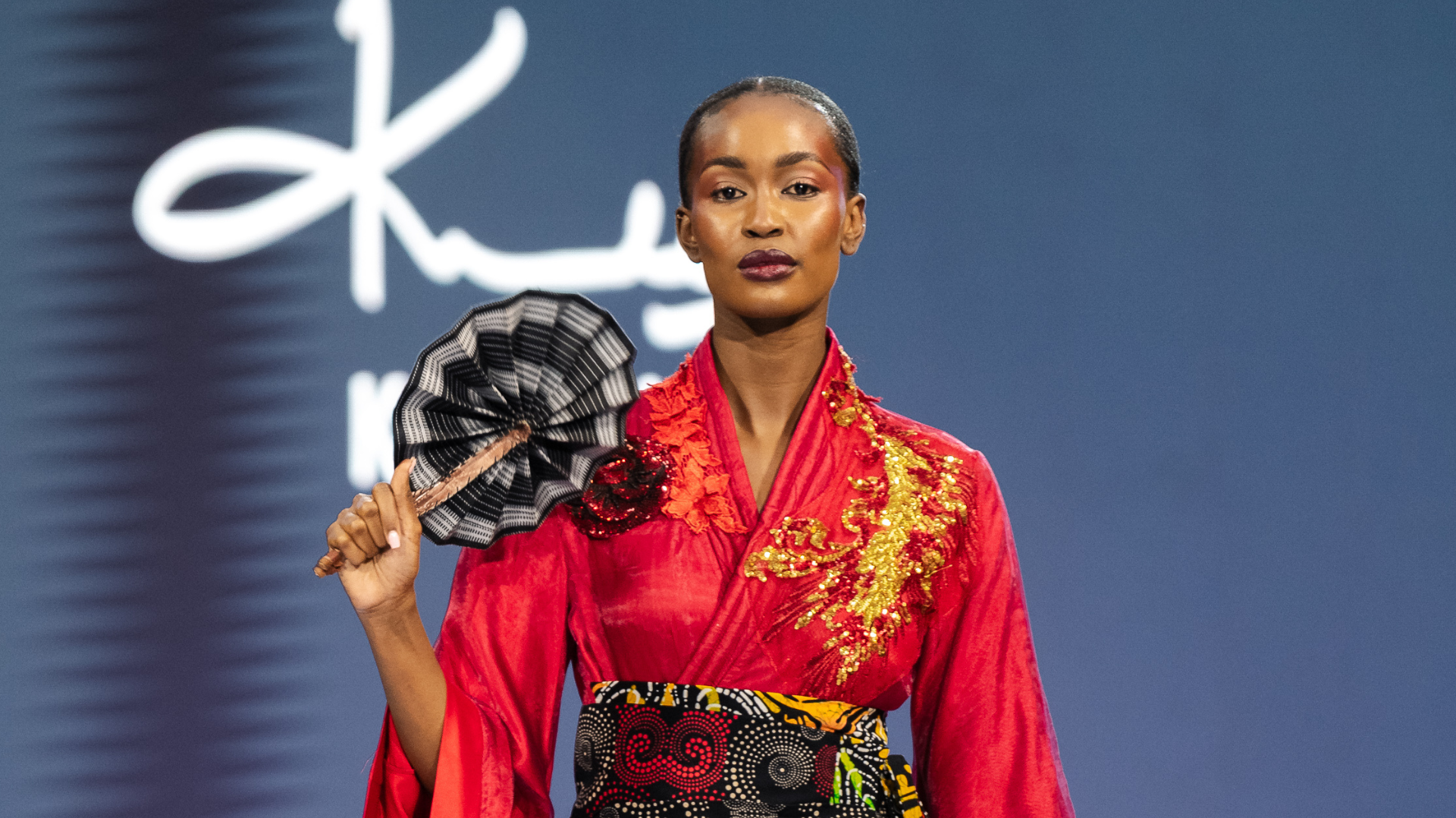 John Kaveke walks the eighth season at Sarit Expo Centre, where Japanese tailoring meets Samburu cultural reference under Brian Kihindas's editorial title Decarbonize. — Photography: Jenkins Kuyoh