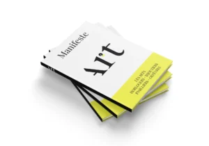 Three copies of the printed Manifeste Art stacked on white, the cover in white with a yellow band reading Les Arts Horlogers, Bijoutiers, Joailliers, Orfevres.