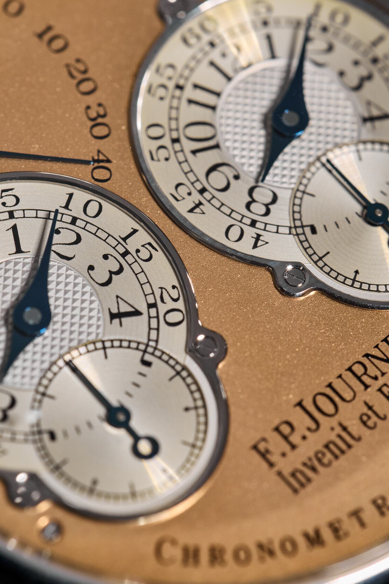 Macro of the two F.P. Journe Souscription No. 007 dials, blued steel hands over guilloché centres, F.P. Journe Invenit et Fecit engraving on the salmon dial