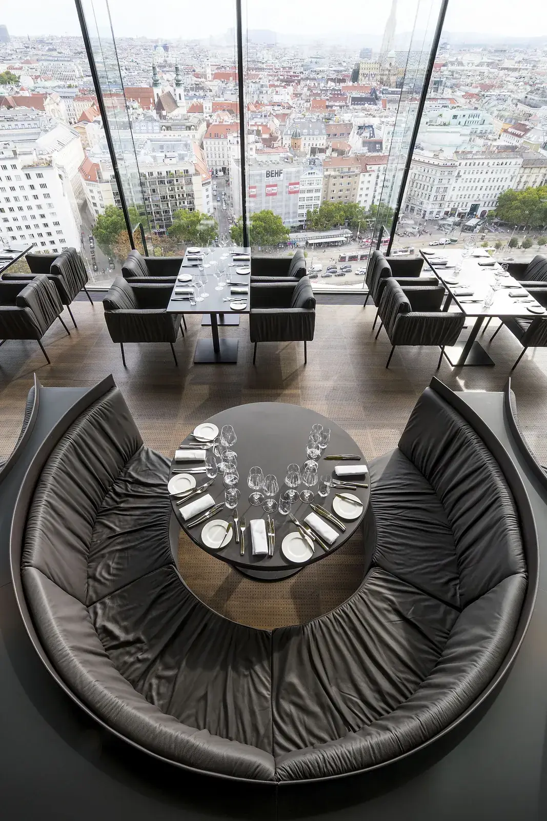 A round, enclosing banquette at Das LOFT seen from above.