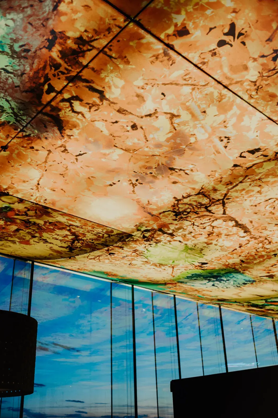 The illuminated ceiling by Pipilotti Rist at Das LOFT, meeting the glass façade and the sky.