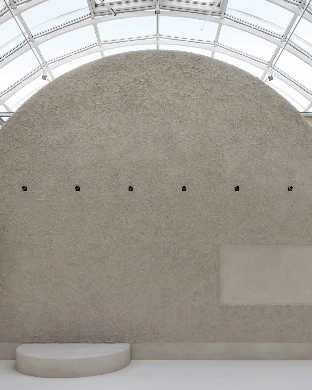 Arched exhibition hall under the glass roof at Design Museum Gent