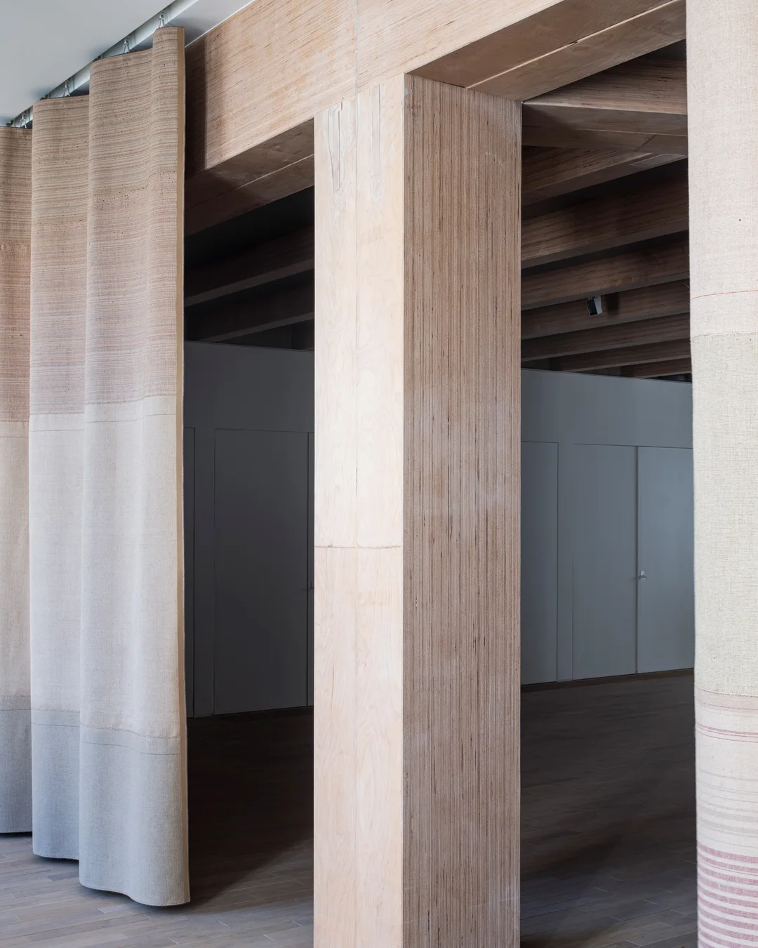 Timber structure and textile curtains inside the new wing of Design Museum Gent