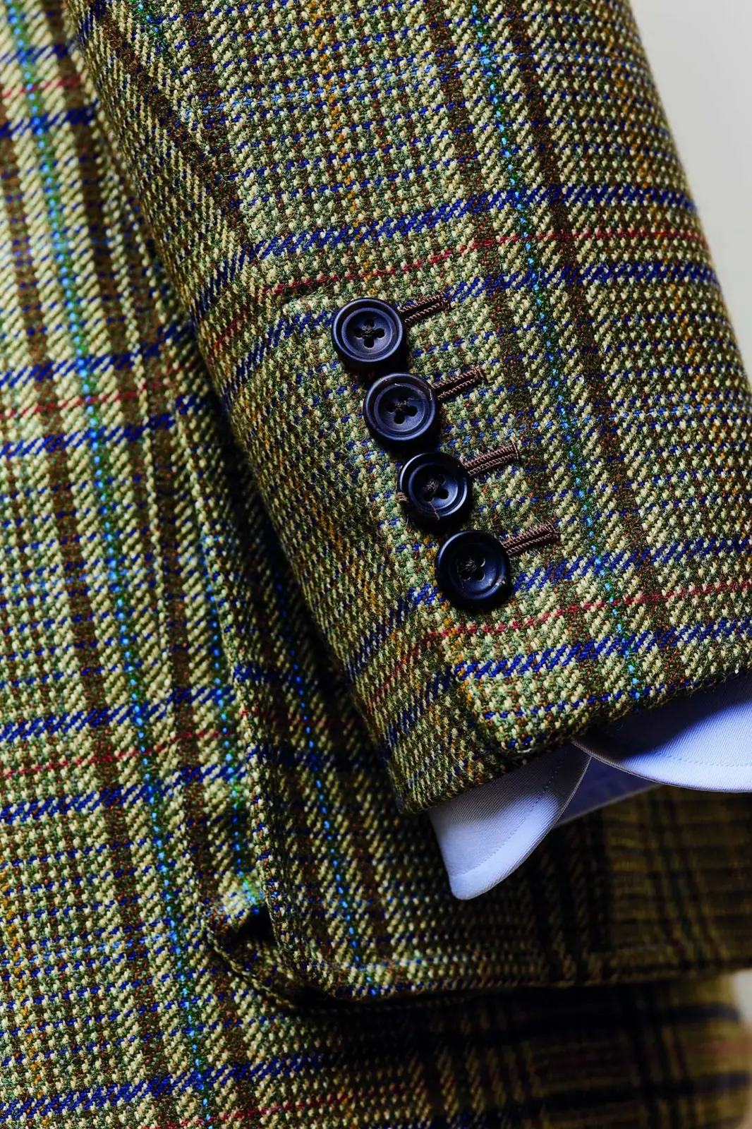 The sleeve of a checked Hackett tailored jacket with four buttons at the cuff.