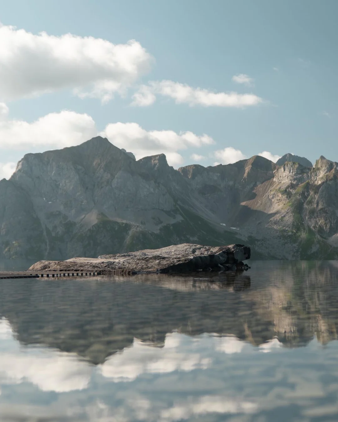 The Lech Mountain Mirror by Snøhetta, a reflecting pool with a rock on the roof of the Zugerbergbahn above Lech