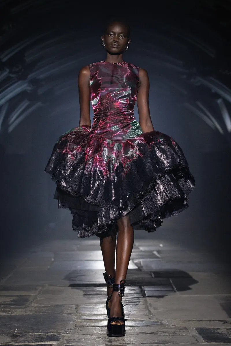 McQueen Spring/Summer 2027, London Fashion Week, 20 September 2026: metallic magenta and black dress with a tiered skirt