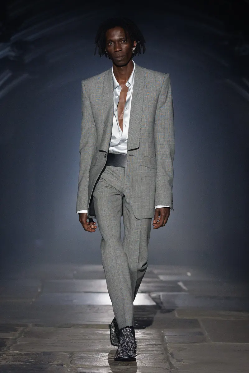 McQueen Spring/Summer 2027, London Fashion Week, 20 September 2026: grey Prince of Wales check suit with an open satin shirt