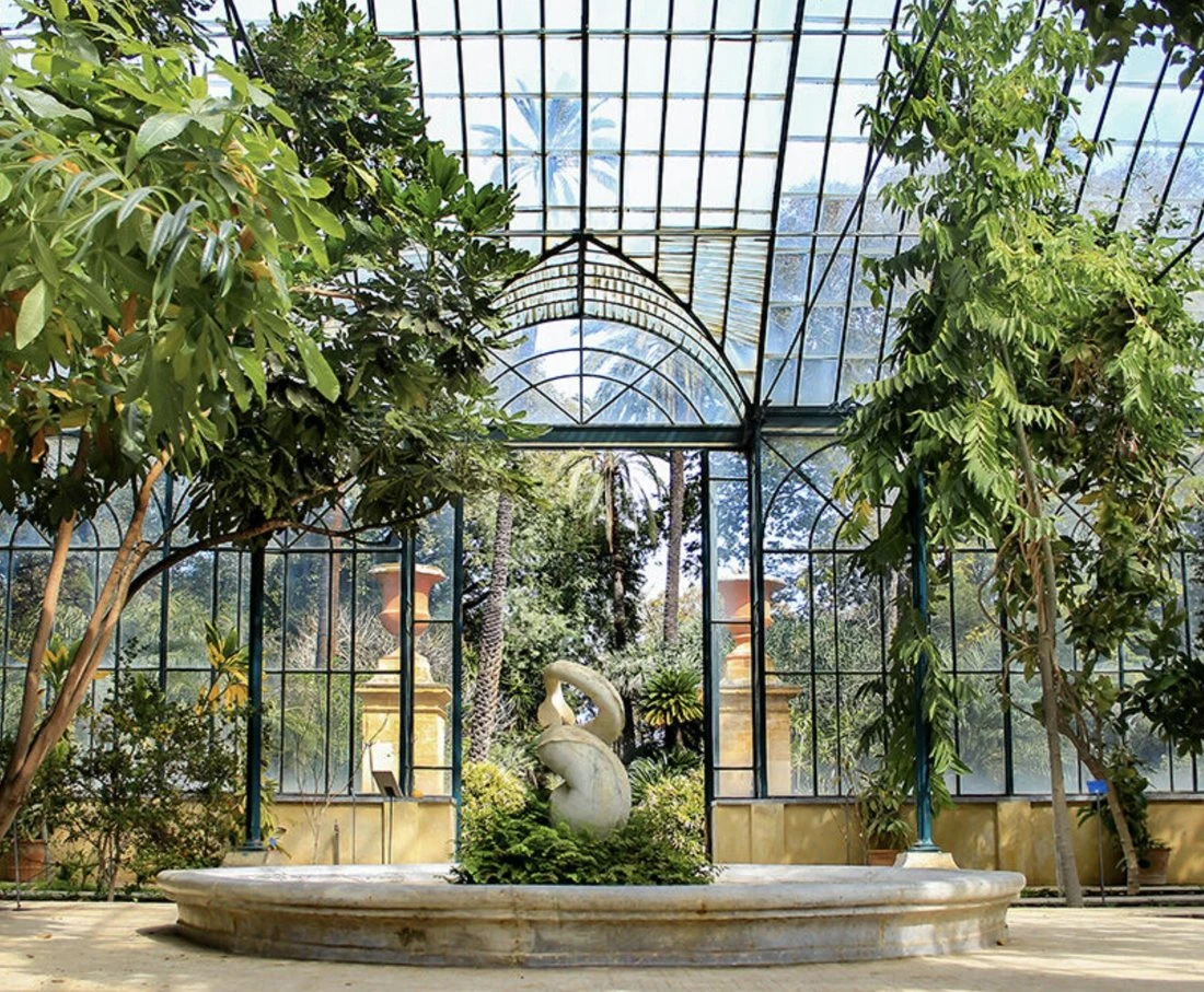 The great glasshouse of the Orto Botanico di Palermo, with a fountain at its entrance