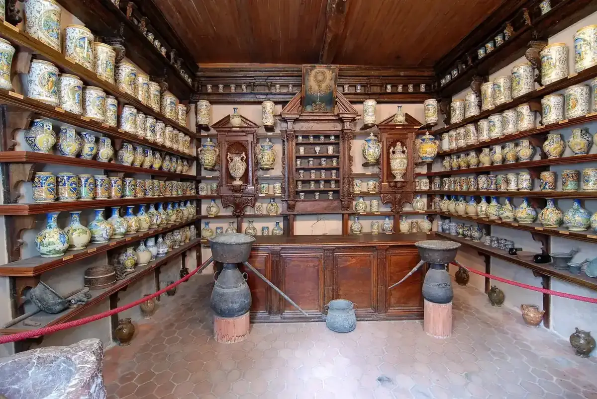 The old pharmacy of Roccavaldina near Messina, with painted majolica jars on carved wooden shelves