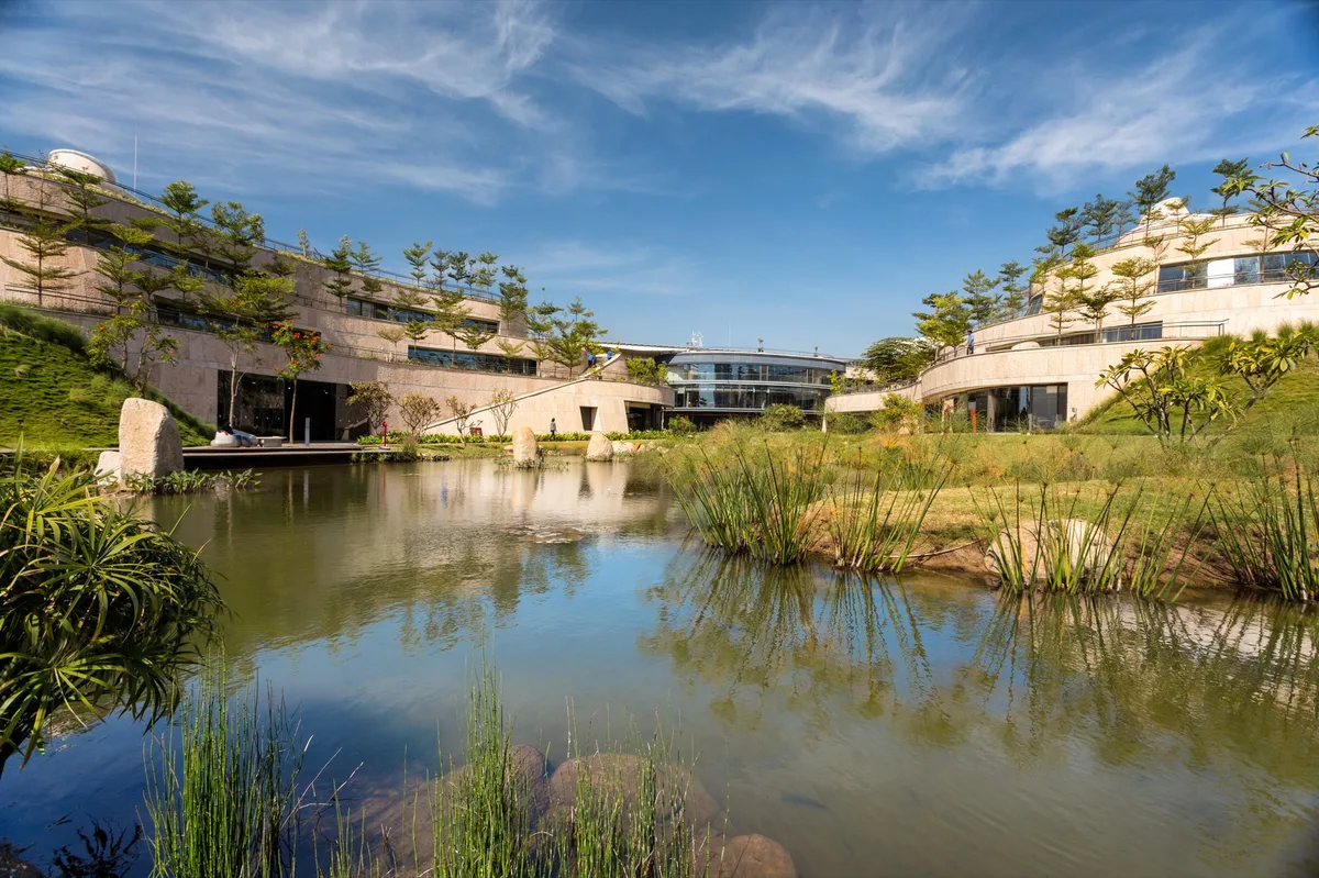 Titan's Integrity Campus in Electronic City, Bengaluru, with terraced buildings around a lake, designed by Mindspace with ONE Landscape Design