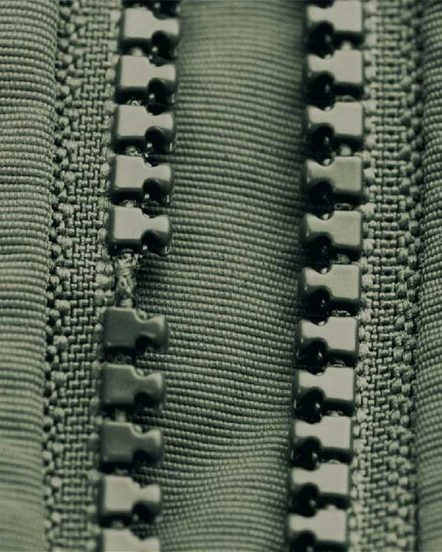 A YKK zipper with one element missing, before the repair