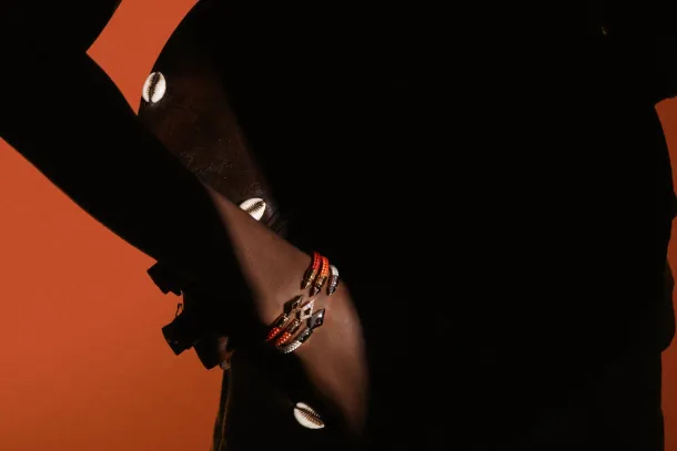 Stacked Fullord bracelets on a wrist in silhouette. Courtesy of Fullord Geneva