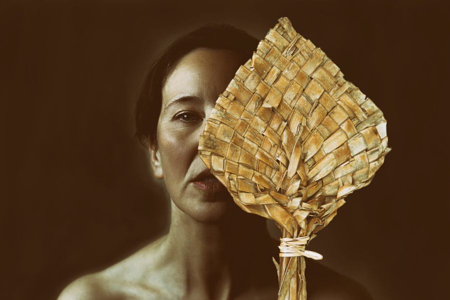 portrait of woman with paypay covering her half face