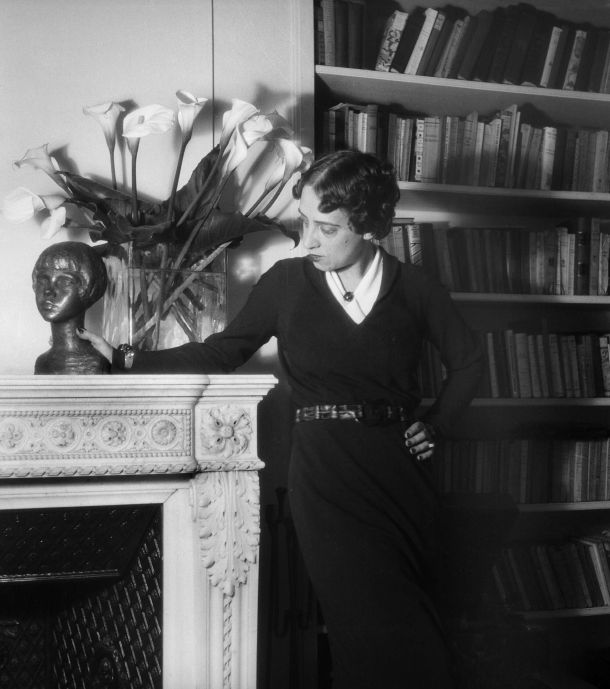 Elsa Schiaparelli at home, among books and arum lilies, 1936. Photograph by Boris Lipnitzki. Credit: APA-Images / Roger Viollet / Boris Lipnitzki.