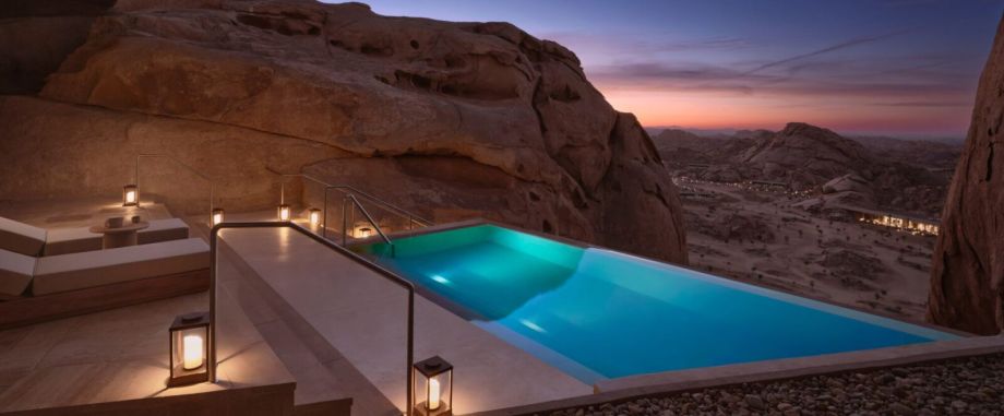 Infinity pool at Desert Rock Resort, integrated into the rocky Hejaz Mountains landscape at sunset, symbolizing luxury, slow hospitality and architectural harmony with nature.