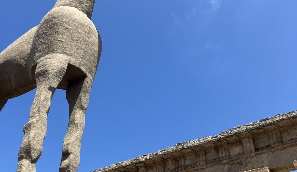 A sand sculpture of a horse before the columns of the Temple of Neptune at Paestum, the ancient Greek city of Poseidonia in the Cilento, southern Italy.