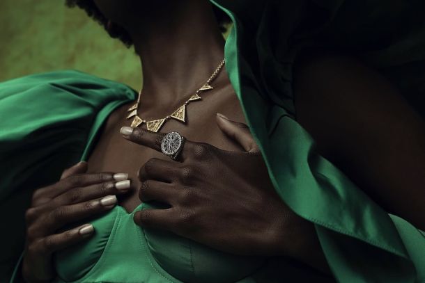 Lola Fenhirst, Lagos. Gold collar and woven ring against sculptural emerald volume.