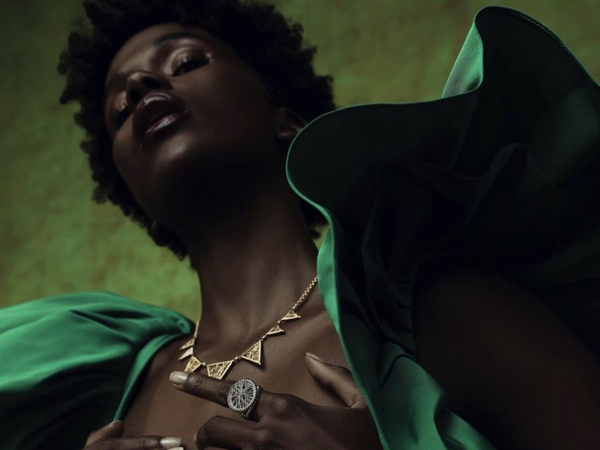 Lola Fenhirst, Lagos. Gold collar and woven ring against sculptural emerald volume.