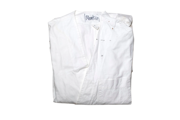 Lot 16, the white studio coat Martin Margiela wore in his atelier, signed "Martin" at the collar. Est. €6,000–10,000. Courtesy of Maurice Auction & Kerry Taylor Auctions