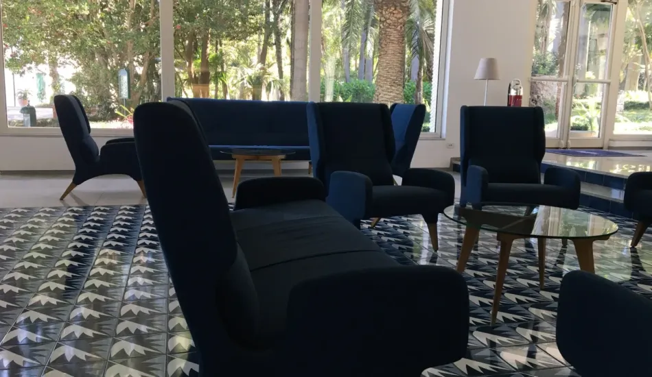 The lobby of the Parco dei Principi in Sorrento, opened in 1962. Gio Ponti designed thirty majolica tile patterns for the hotel, and no two repeat. The chairs kept the cobalt he borrowed from the gulf outside. | Photo: Eva Winterer