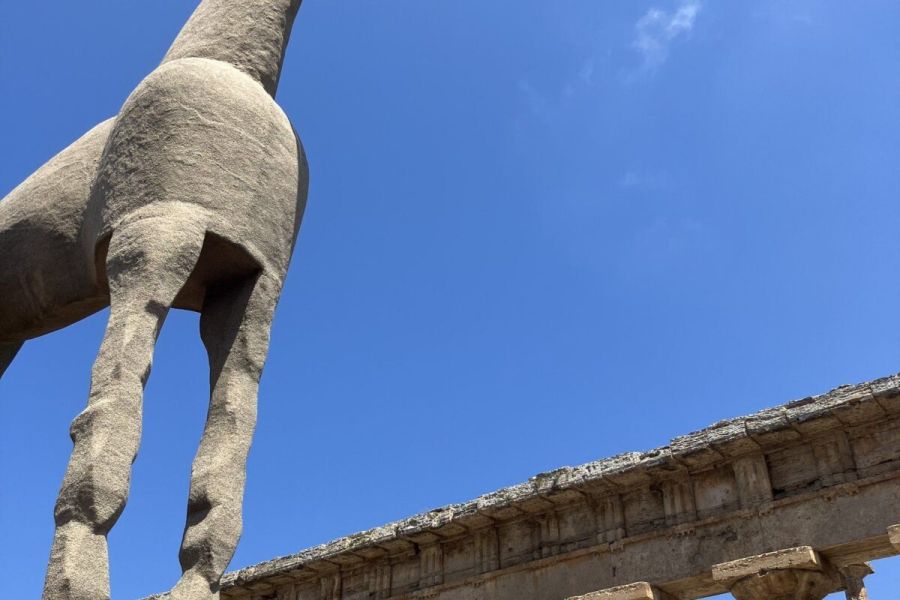 A sand sculpture of a horse before the columns of the Temple of Neptune at Paestum, the ancient Greek city of Poseidonia in the Cilento, southern Italy.